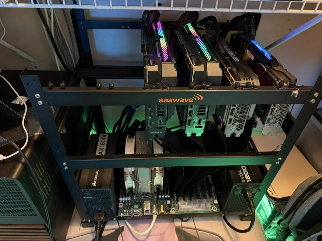 Open-frame GPU rig on a wire shelf: four RTX 3090s mounted on an aaawave mining frame with an EPYC server board and dual power supplies below
